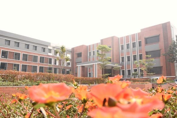 BITE Varanasi campus garden with flowering plants and seating